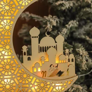 Close-up of wooden Eid moon ornament featuring laser-cut mosque and warm LED lighting
