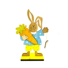 Detail der Holz-Hasenfigur mit Karotte und Blumenhemd auf gelbem Sockel