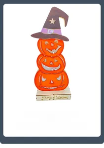 Detail of laser cut wooden Halloween decor with stacked pumpkins and witch hat