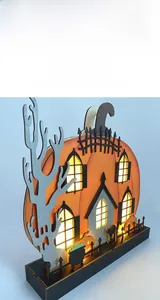 Detailed laser-cut wooden pumpkin house with warm LED light and spooky Halloween motifs
