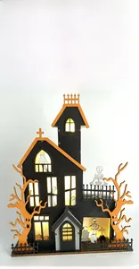 Detail of laser-cut wooden Halloween castle with warm LED lights and ghost spooky elements