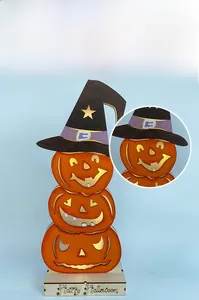 Detail of wooden stacked pumpkin LED lamp with witch hat and Happy Halloween engraving