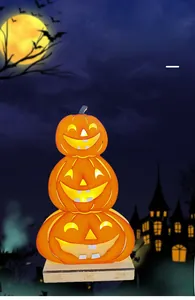 Close-up of three-tier glowing wooden Jack-O-Lantern pumpkins with spider base decoration
