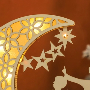 Macro view of wooden moon lamp with laser-cut floral patterns and warm LED glow