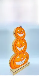 Macro detail of laser-cut wooden Halloween pumpkin layers on a patterned base