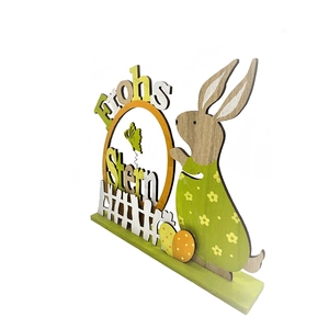 Detail of wooden Easter desktop decoration featuring bunnies, eggs, and Frohe Ostern text