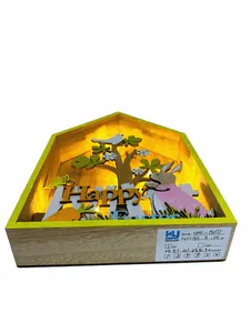 Detail of illuminated wooden Easter house ornament with Happy Easter sign and warm LED light