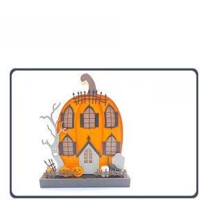 Detail of wooden Halloween pumpkin house ornament with LED light and festive hand-painted crafts
