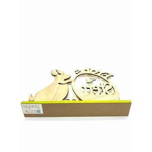 Macro detail of laser-cut wooden Easter decoration featuring Frohes Ostern text and rabbit