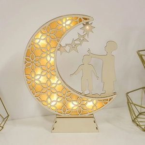 Wooden Ramadan moon ornament with LED lights and laser-cut floral patterns on a base