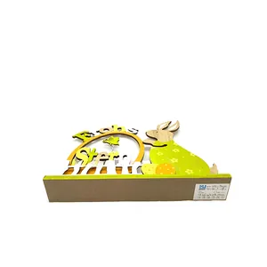 Macro detail of wooden Easter bunny decoration with Frohe Ostern text and multi-layer wood art