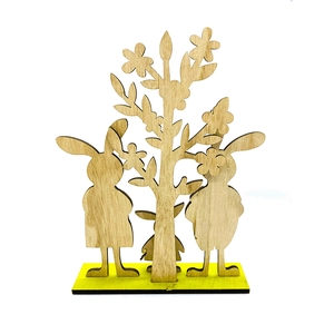 Minimalist laser-cut wooden rabbit and tree craft ornament on a yellow base stand