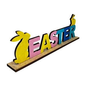 Detail of colorful wooden Easter letter stand with yellow bunny silhouettes on a natural base