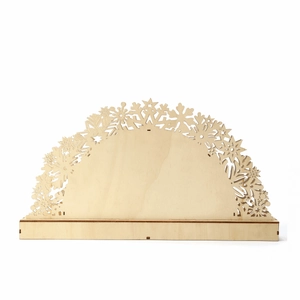 Detail of laser-cut wooden Christmas bridge light with intricate snowflake patterns