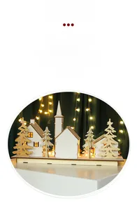 Detail of wooden Christmas village ornament with warm LED lights and Nordic cutout trees