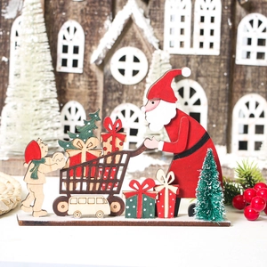 Detail of wooden Santa Claus ornament with a gift trolley for Christmas table decoration