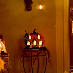 Lighted Halloween pumpkin house decoration with LED lights and spooky cutout silhouettes