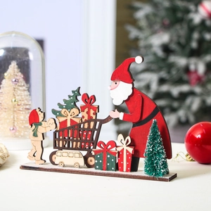 Detail of wooden Christmas table ornament featuring Santa Claus with gift cart and tree