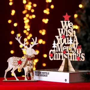 Detail of wooden Christmas deer and tree ornament with warm LED bokeh background