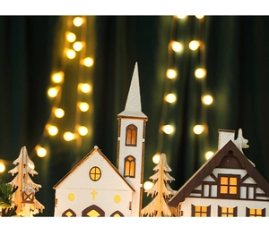 Macro detail of wooden Christmas village with warm LED lighting and intricate cutouts