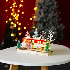 Detail of illuminated wooden Christmas RV ornament with LED lights and holiday miniatures