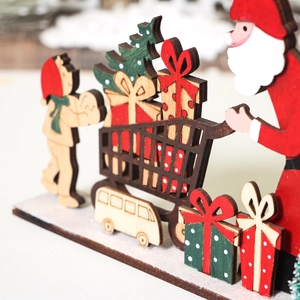 Detail of layered wooden Christmas ornament featuring Santa and festive cart graphics