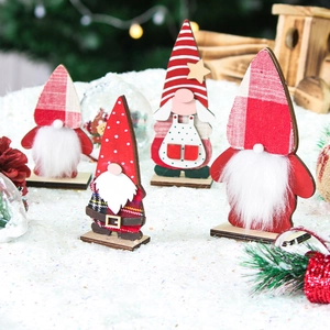 Set of four festive wooden Christmas gnomes with textured beards on snowy background