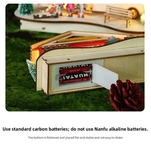 Detail of wooden Christmas bus model showing battery compartment with LED power setup