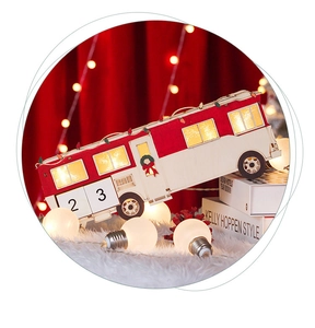 Macro detail of wooden Christmas bus calendar with warm LED lights and red velvet decor