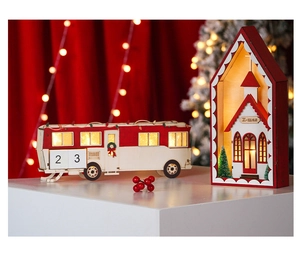 Detail of wooden LED Christmas camper and lantern with warm glowing holiday lights