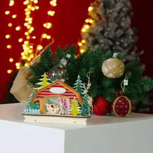 Detail of a Christmas glowing wooden cabin with miniature snowman and LED festive lights