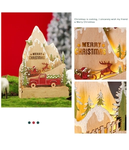 Detail of wooden Christmas LED decor showing laser-cut forest and reindeer scenery