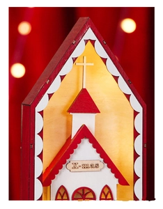 Detail of wooden Christmas church ornament with X-mas carving and festive red finish