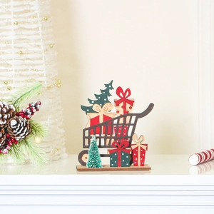 Detail of wooden Christmas cart ornament with mini tree and gift boxes on a natural base