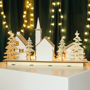 LED lighted Christmas wooden village scene with white houses and pine trees on base