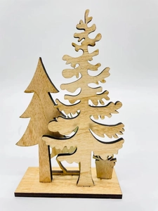 Detail of laser-cut wooden Christmas trees with natural grain on a square base