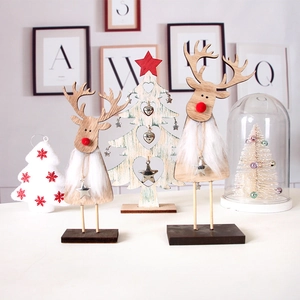 Detail of wooden Christmas reindeer figurines with red nose and star pendants on a desk