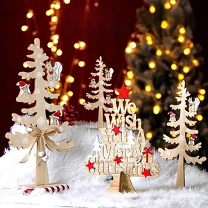 Close-up of three wooden Christmas tree ornaments with snow carvings and merry greetings