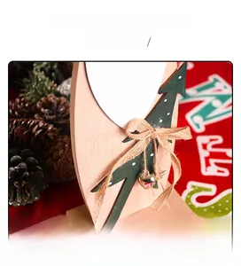 Détail de sapin de Noël en bois avec nœud en toile de jute et petites clochettes