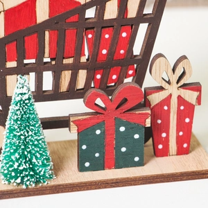 Christmas wooden gift box ornament with a miniature frosted pine tree on desktop