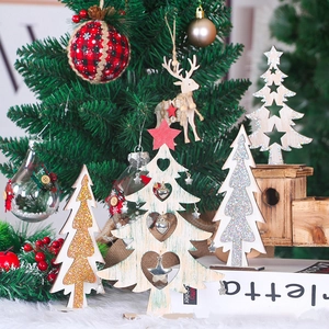 Macro detail of wooden Christmas tree ornaments with hollow hearts and metal bells