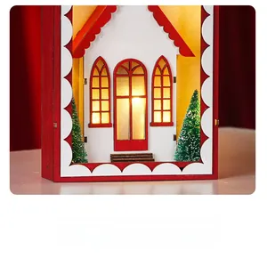 Macro view of Christmas wooden LED light box with red frame and warm white house cutout