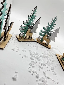 Detailed laser-cut wooden Christmas tree and reindeer desktop ornament with fake snow