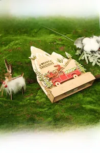 Detail view of wooden Christmas desk ornament with reindeer and festive mountain backdrop