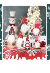 Detail of wooden Christmas gnomes with plaid hats and white beards on festive tabletop