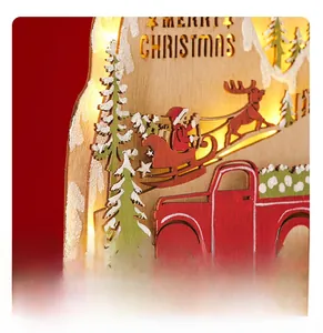 Detail of wooden LED Christmas ornament with laser-cut Santa and red truck scene