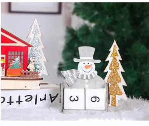 Detail view of 24cm wooden snowman calendar with red shop and glitter Christmas trees