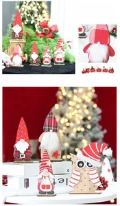 Detail of wooden Christmas gnome figurines and a red toy train for holiday desk decor