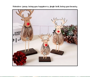 Detailed view of three wooden reindeer figurines with fur trim and silver heart charms