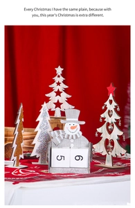 Detailed view of wooden snowman calendar and glittery Christmas tree tabletop decorations